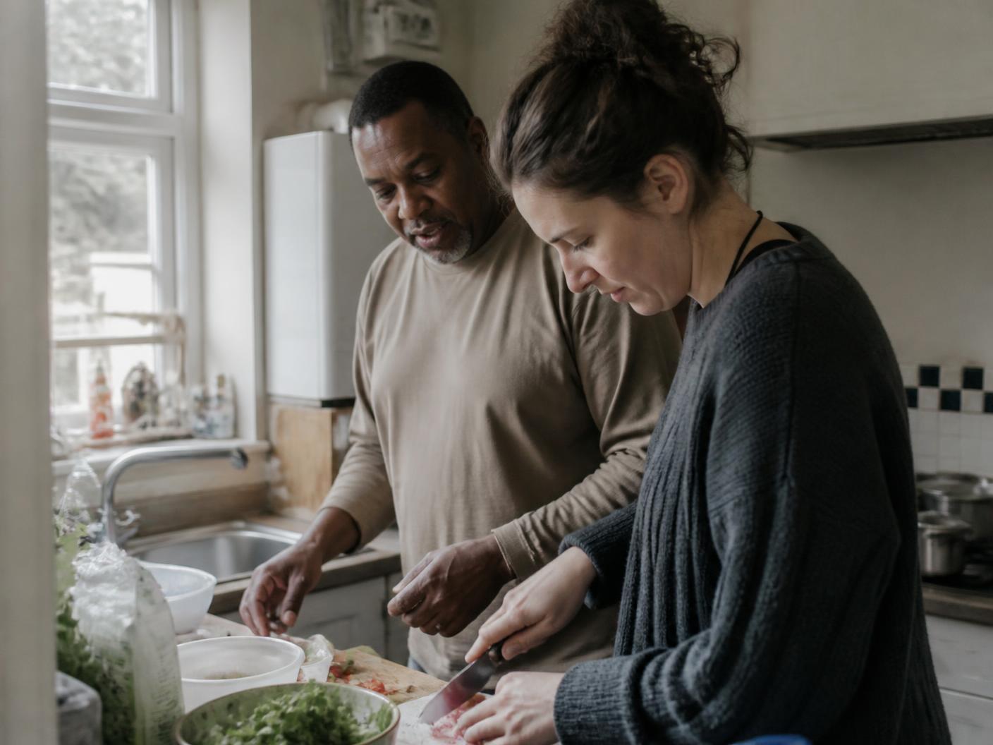 Two residents preparing a meal together in a shared kitchen